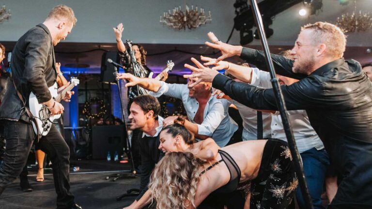 Shades of Blue wedding Band with Crowd Reaching for Lead Guitar Player on Stage